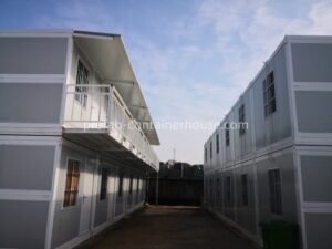 Finished two-story modular complex built using durable folding container houses