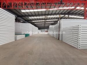 Stacks of flat-pack and folding container house components ready for international shipping from China