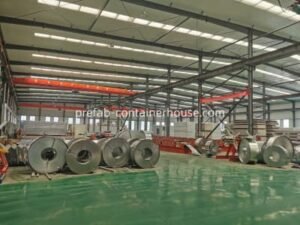 Wide view of Sunfine 16,000m² workshop showing raw steel coils for modular house container manufacturing
